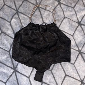 Black halter crop top with good chain around neck.